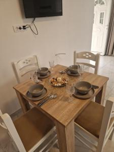 a wooden table with a plate of food on it at IVANA Apartments in Ulcinj