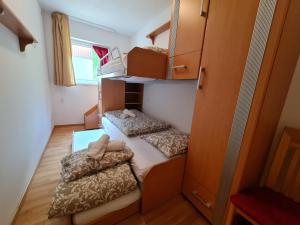 a small room with two beds in a dorm room at Haus Lilly by Globalimmoservice in Bad Kleinkirchheim