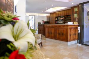 a lobby with a bar and some plants in a room at Hotel alla giustizia in Mestre