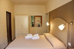 1 dormitorio con 1 cama con toallas en Art Hotel Pandos, en Tabiano