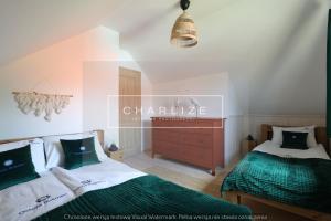 a bedroom with two beds and a dresser at Ale Lipa - Ostoja Bukowo in Borowy Młyn +19 photos