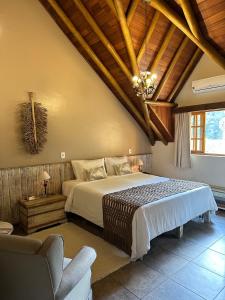 A bed or beds in a room at Pousada Da Pedra
