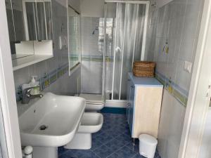 a bathroom with a sink and a toilet and a shower at Casa Ginny in Ospedaletti