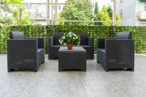 a group of chairs and a table with flowers at Hotel alla giustizia in Mestre
