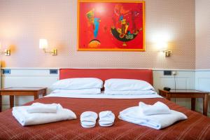 a bedroom with a bed with two towels on it at Hotel alla giustizia in Mestre