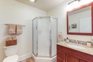 a bathroom with a shower and a toilet and a sink at The Farmhouse at 1885-Where Past Meets Present in Navarre +18 photos