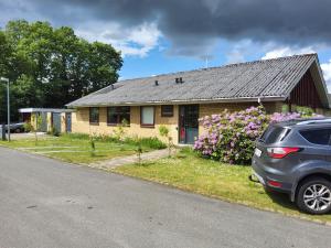 a house with a car parked in front of it at Family Friendly Apt A, Garden, 900m LegoHouse, Lalandia, Legoland in Billund