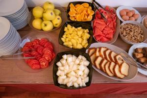 a table filled with different types of fruits and vegetables at Hotel alla giustizia in Mestre