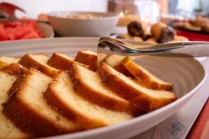 a plate of waffles with a fork and a spoon at Hotel alla giustizia in Mestre