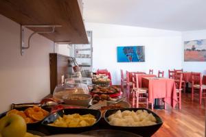 a table topped with lots of different types of food at Hotel alla giustizia in Mestre