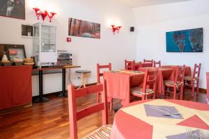 a restaurant with tables and chairs and a desk at Hotel alla giustizia in Mestre