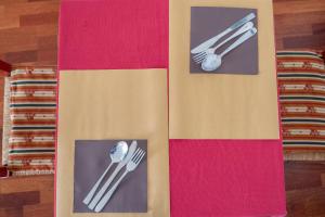 two pictures of fork and spoon on a colorful wall at Hotel alla giustizia in Mestre