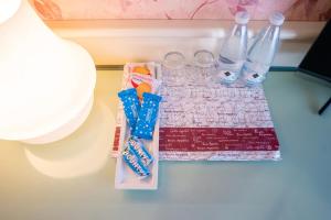 a table with glasses and bottles on a table at Hotel alla giustizia in Mestre