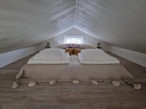 a bedroom with two beds in a attic at Charmant hus med bastu och braskamin in Alingsås