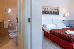 a bedroom with a bed and a bathroom with a toilet at Hotel alla giustizia in Mestre +37 photos