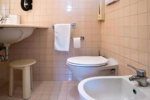 a bathroom with a toilet and a sink at Hotel alla giustizia in Mestre