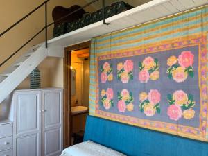 a bedroom with a painting of flowers on the wall at Villa CieloMare in Camogli