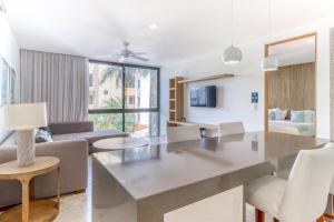 a kitchen and living room with a table and chairs at Anah Suites #202 N in Playa del Carmen +18 photos