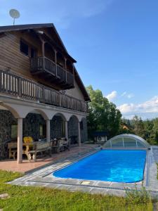 a swimming pool in front of a house at Chata Porubka in Liptovský Mikuláš