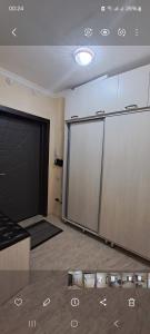 um quarto vazio com uma garagem com uma porta grande em 2-комнатная квартира в административном центре. em Türkistan