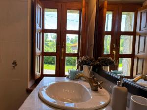 a bathroom with a sink and a window at Casa Rural El Salvijo in Monte +52 photos