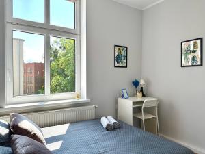 a bedroom with a bed and a window at MMRent Leaf Room in Gdańsk
