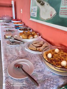 uma mesa longa com pratos de comida em Pousada Galinhos em Galinhos