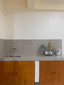 a kitchen with a sink and a counter top at Llaguno City Inn in General Santos
