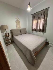a bedroom with a bed and a window at ΚΟΧΥΛΙ in Ierissos