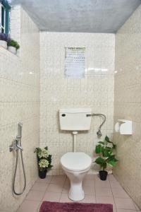 a bathroom with a toilet and a shower at U.R.D.Ki Hostel in Anjuna