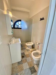 a bathroom with a toilet and a sink at Bobi’s House in Chacras de Coria