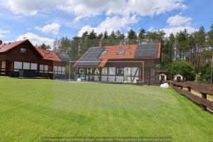 a house with solar panels on the roof at Ale Lipa - Ostoja Bukowo in Borowy Młyn