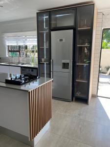 a kitchen with a stainless steel refrigerator and a counter at Maso palace in Polokwane