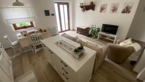 a living room with a couch and a table at All'ombra del tiglio Bed&Breakfast in Doberdò del Lago
