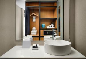 a bathroom with a large white sink in a room at Aloft Chicago Downtown River North in Chicago +36 photos