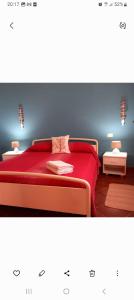 a bedroom with a bed with a red blanket at Apartment Mini Monaco in Castelluzzo