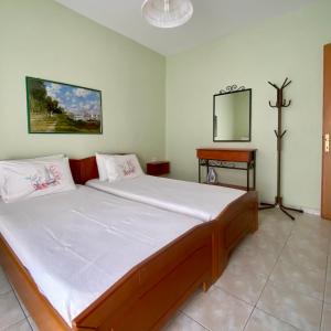 a bedroom with a large bed in a room at Apartments Thomoglou in Keramoti