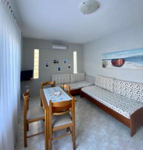 a living room with a couch and a table at Apartments Thomoglou in Keramoti