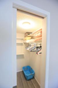 a walk in closet with a blue stool at Updated Condo with Pool, Walk to Crescent Beach & Restaurants! in Sarasota