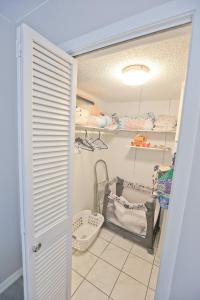 a childs room with a baby crib and shelves at Updated Condo with Pool, Walk to Crescent Beach & Restaurants! in Sarasota