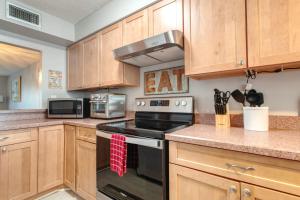 a kitchen with wooden cabinets and a stove top oven at 2 bed 2 bath centrally located on Siesta Key in Sarasota