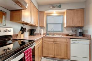 a kitchen with wooden cabinets and a sink at 2 bed 2 bath centrally located on Siesta Key in Sarasota