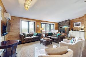 a large living room with couches and a table at Fox Lane Retreat in White River Junction