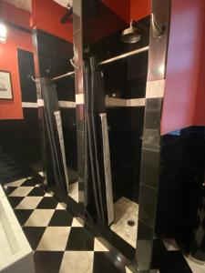 a bathroom with a black and white checkered floor at The Nolita Express Hostel in New York