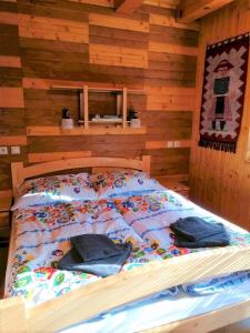 a bed in a log cabin with pillows on it at Chata Porubka in Liptovský Mikuláš +13 photos
