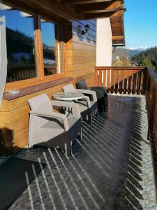 a group of chairs and tables on a deck at Chata Porubka in Liptovský Mikuláš