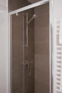 een douche in een badkamer met een glazen deur bij SweetHomeVersailles 5mn walk from the Palace in Versailles