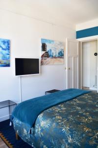 a bedroom with a bed and a flat screen tv at SweetHomeVersailles 5mn walk from the Palace in Versailles