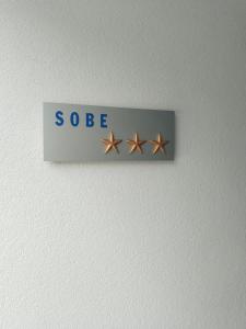 a sign with three stars on a wall at Sobe Lejla in Vipava