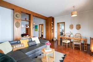 a living room with a couch and a table at Villa Infinito Blu in Borgio Verezzi